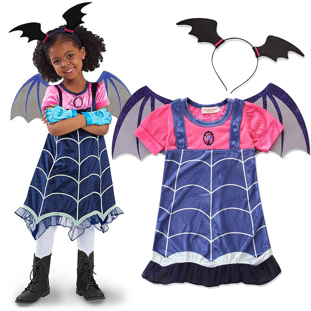 Child wearing a bat-themed costume with pink shirt, blue dress, and black boots, accompanied by a set of bat wings and headband.