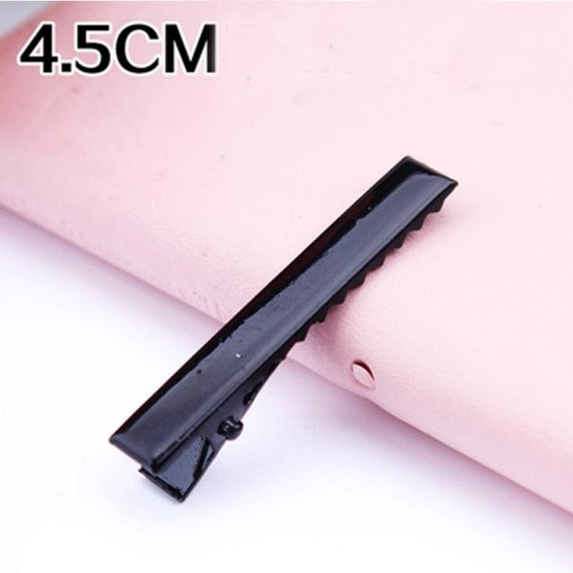 Black hair clip on a pink background with '4.5CM' text