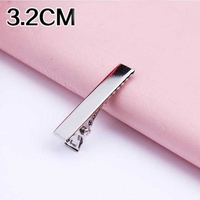 Silver hair clip on a pink background with '3.2CM' text.