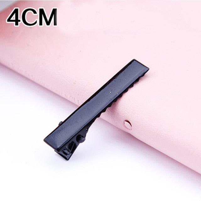 Black hair clip on a pink background with '4CM' text