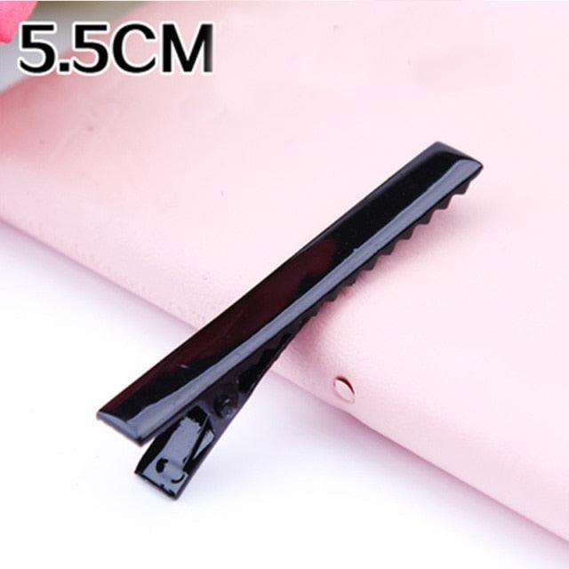 Black hair clip on a pink background with '5.5CM' text