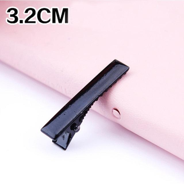Black hair clip on a pink background with '3.2CM' text.