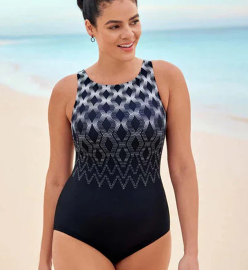 Woman wearing a black and blue patterned swimsuit on a beach