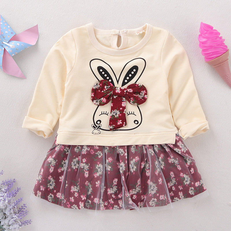 Children's outfit with bunny design and floral skirt on a light background