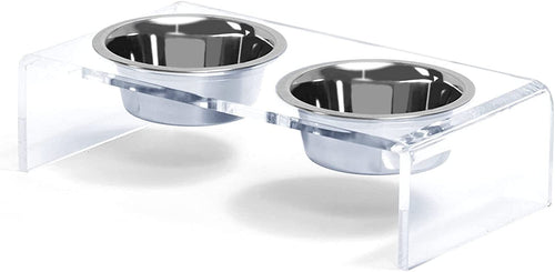Clear acrylic pet feeder with two stainless steel bowls on a white background