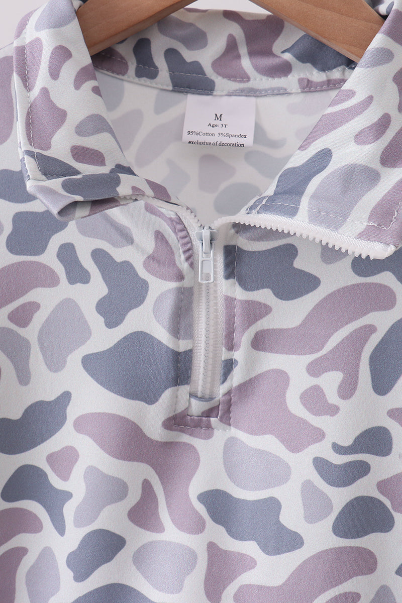 Purple and gray patterned garment on a hanger with a visible brand label.