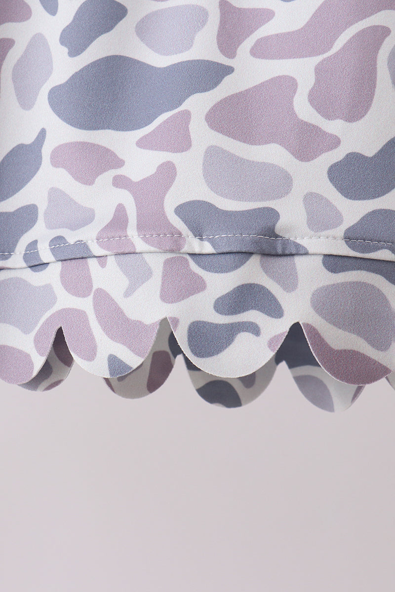 Close-up of a fabric with a purple and gray abstract pattern on a light gray background