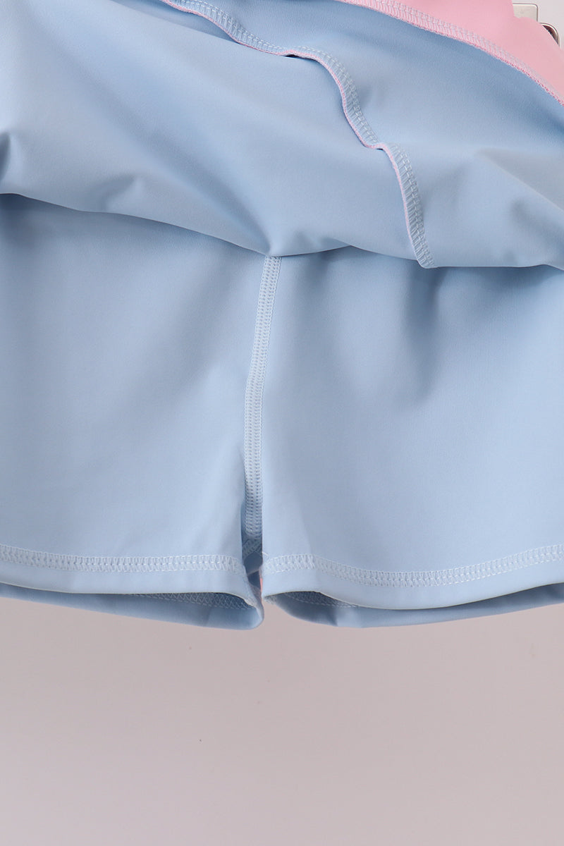 Close-up of light blue fabric with a pink background