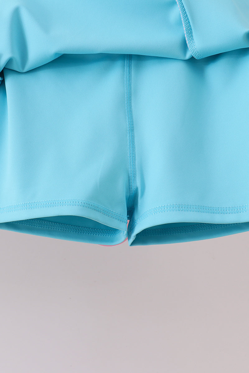 Close-up of light blue shorts on a gray background