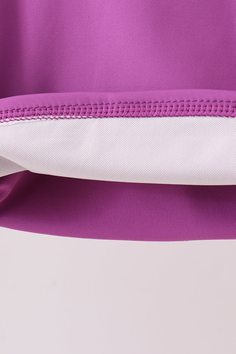 Close-up of a purple and white fabric with a zipper
