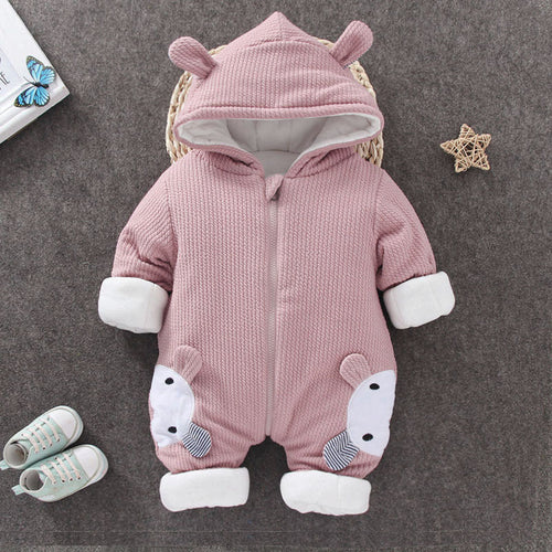 Pink baby romper with animal ears on a gray surface