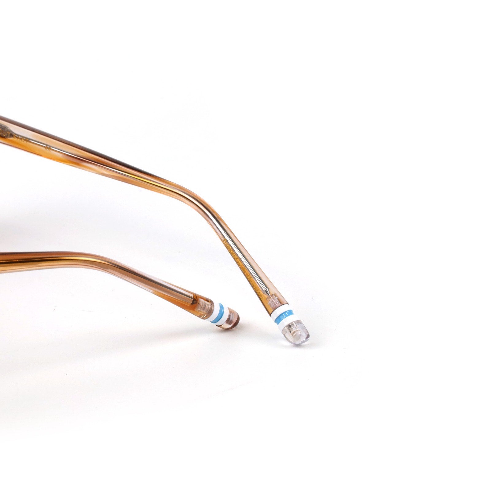 Two curved metal tubes with one featuring a blue and white label on a white background