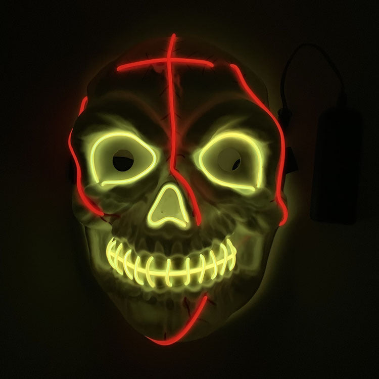 Halloween mask with glowing yellow and red lights on a black background