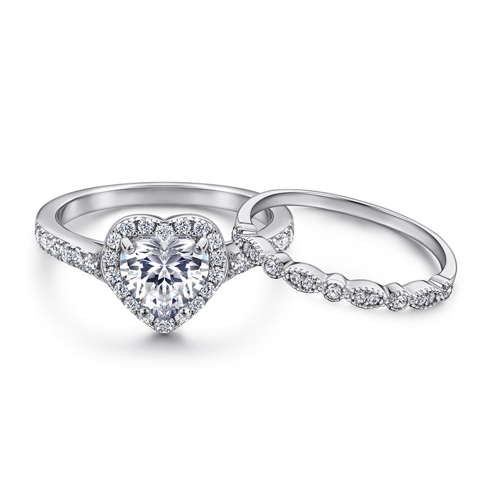 Silver heart-shaped diamond ring on a white background