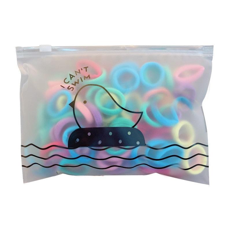 Clear bag with colorful rubber duckies and 'I Can't Swim' text on a white background