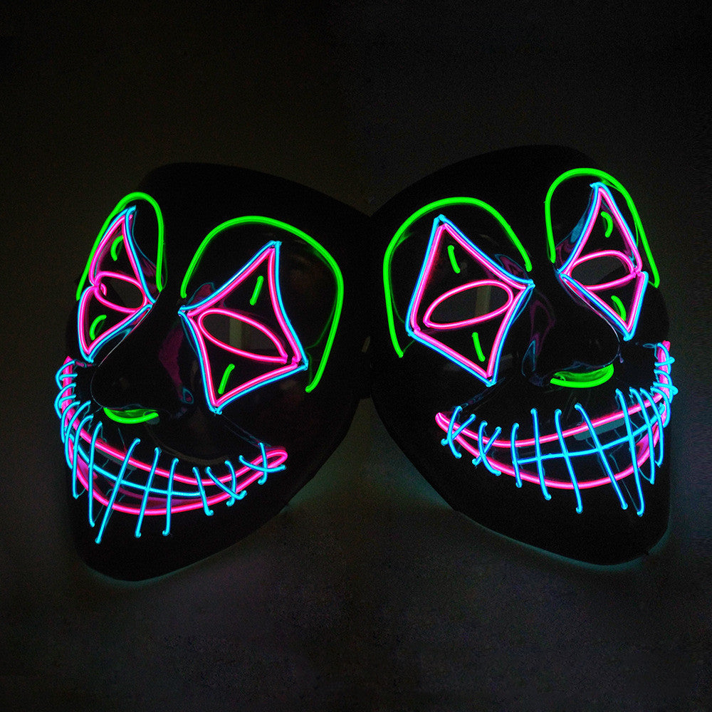 Neon LED mask with pink and green accents on a black background