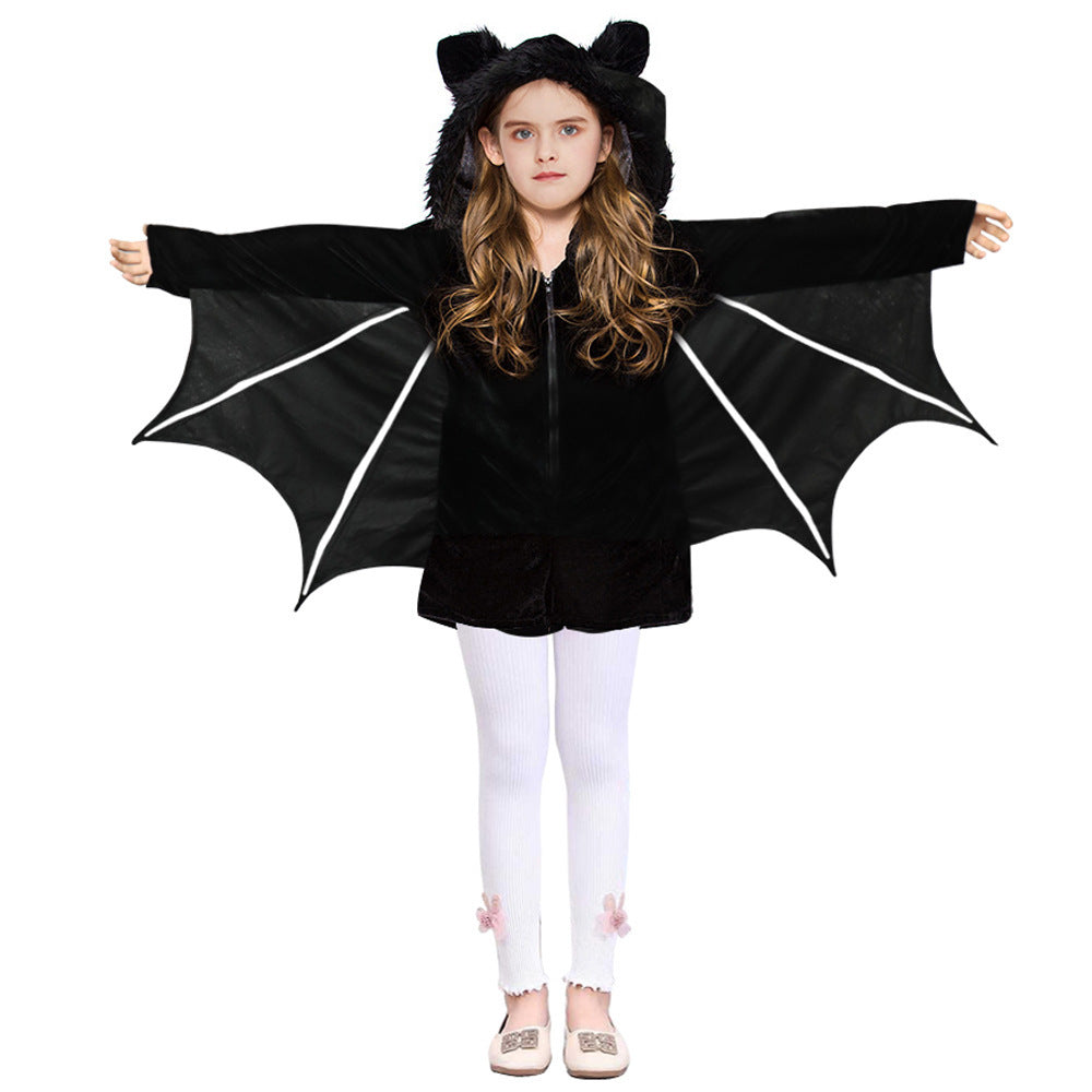 Child wearing a black bat costume with wings on a white background