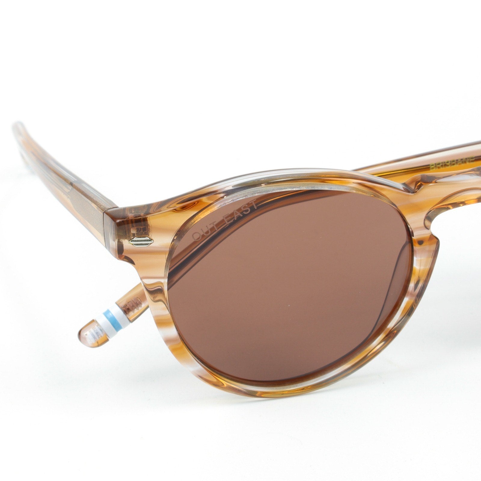Sunglasses with tortoiseshell frame and brown lenses on a white background