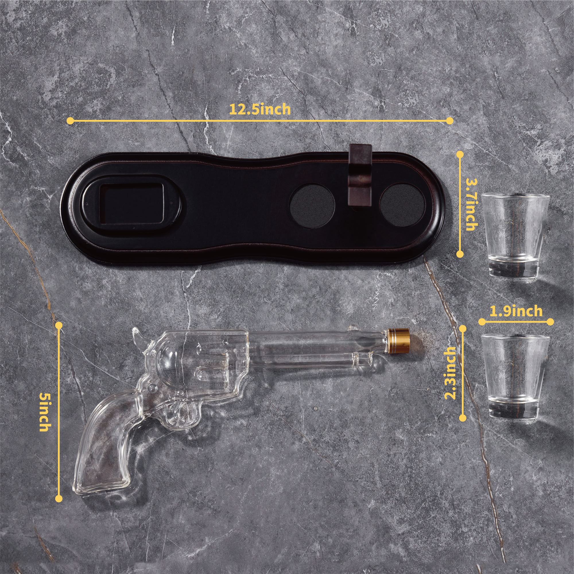 Glass gun-shaped decanter with measurement labels on a gray surface