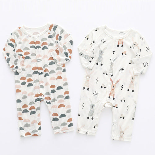 Two baby rompers with different patterns on a white background
