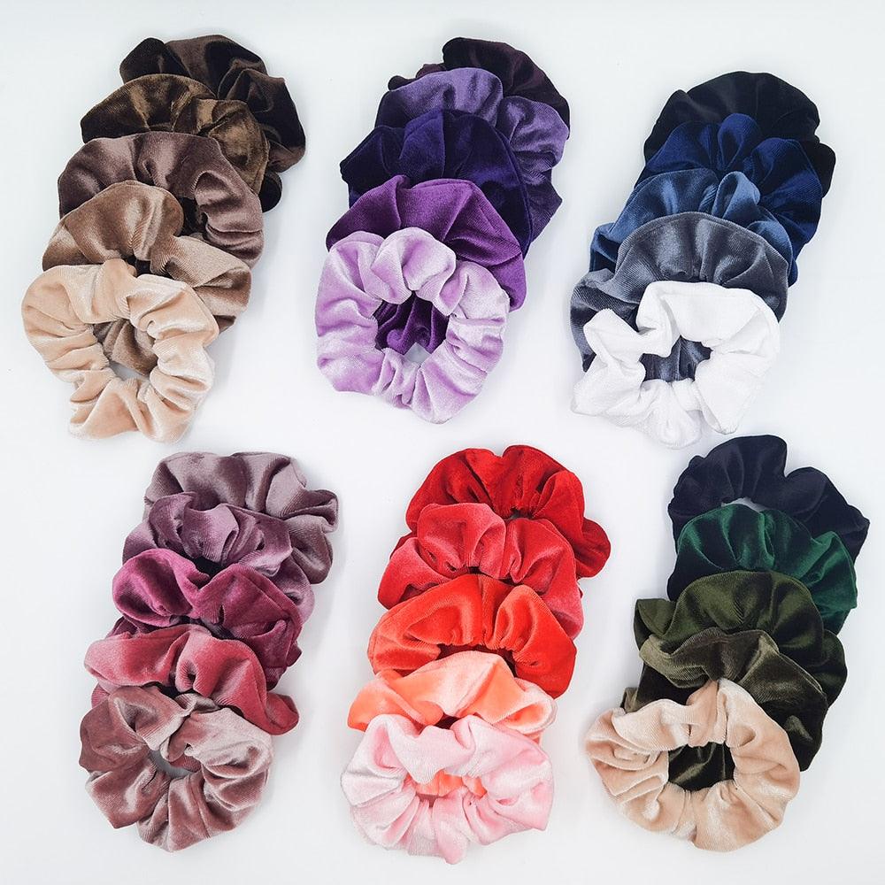 Collection of colorful velvet scrunchies on a white background