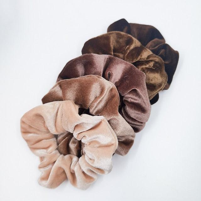 Set of brown and beige scrunchies on a white background