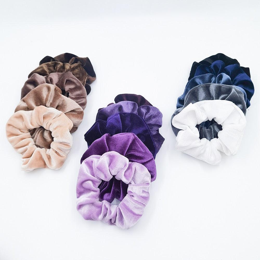 Set of colorful velvet scrunchies on a white background