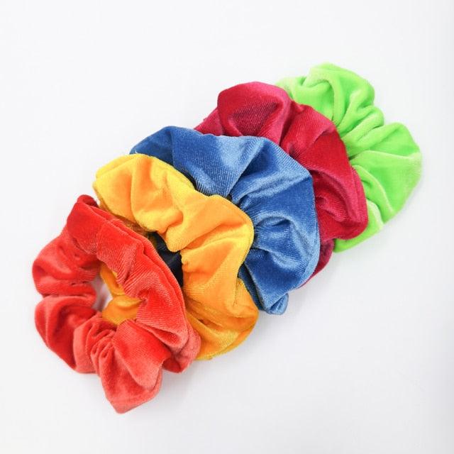 Set of colorful velvet scrunchies on a white background