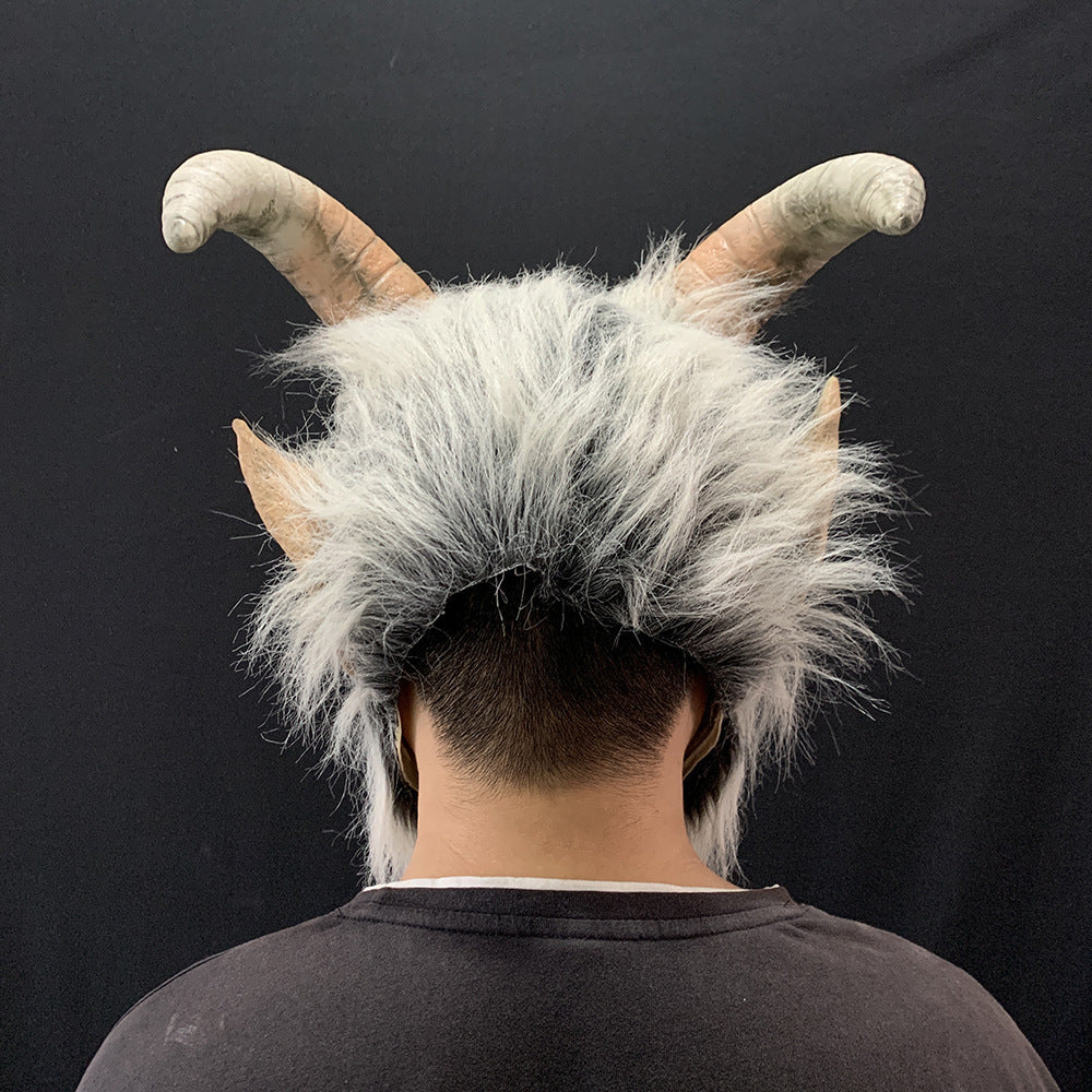 Person wearing a wig with goat-like horns and ears on a black background