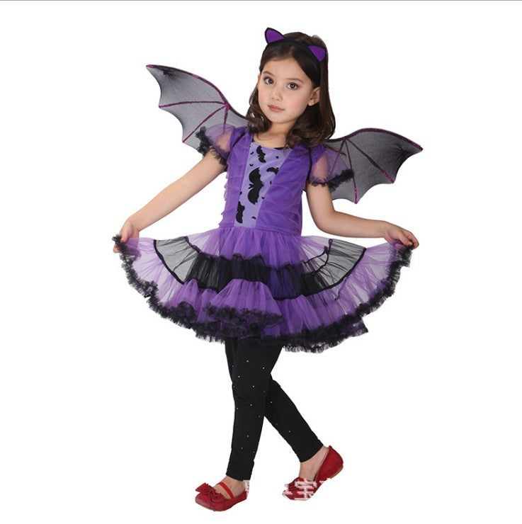 Child wearing a purple and black bat-themed costume with wings on a white background