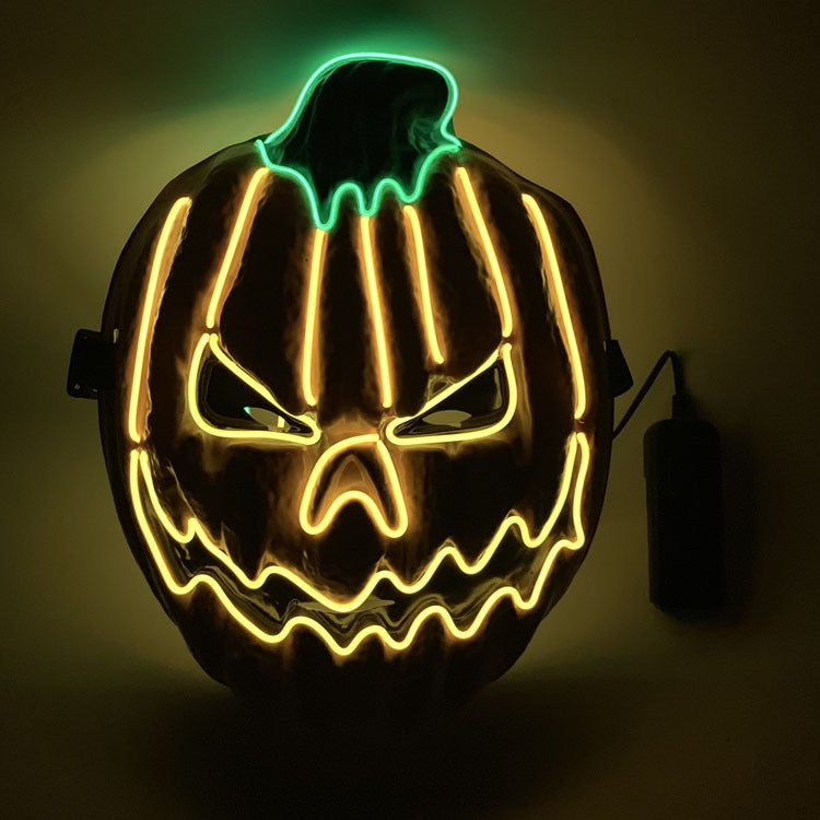 LED pumpkin mask with glowing face on a dark background