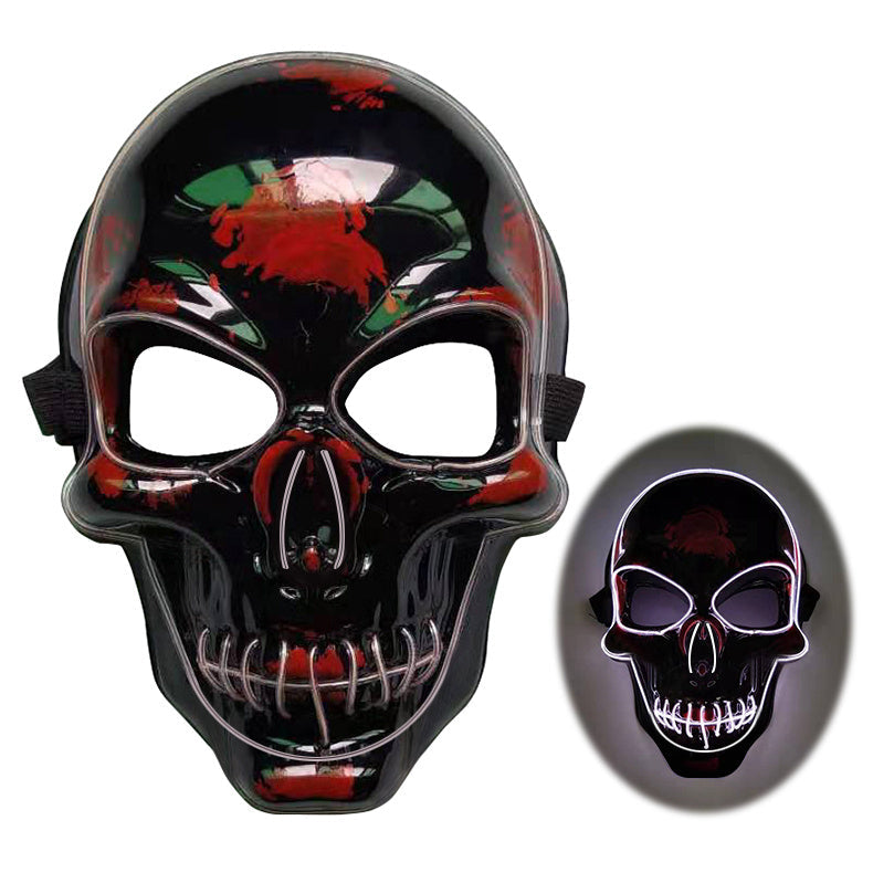 Black skull mask with red and green accents on a white background