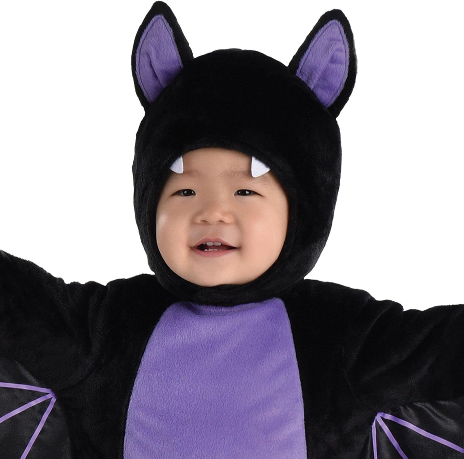 Child wearing a black and purple bat costume on a white background