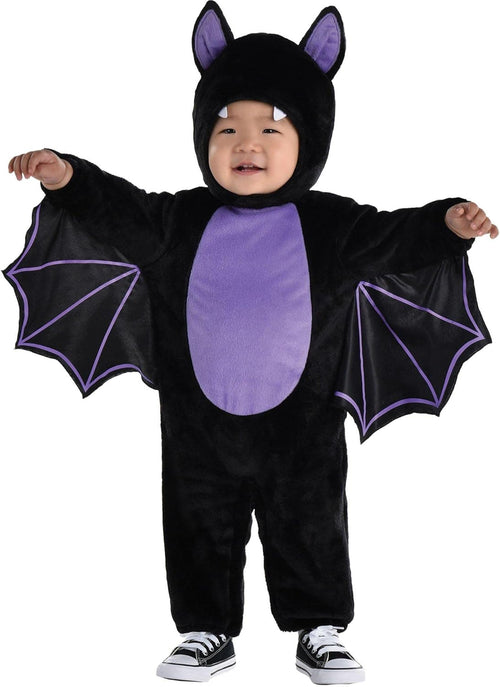 Child wearing a black and purple bat costume on a white background