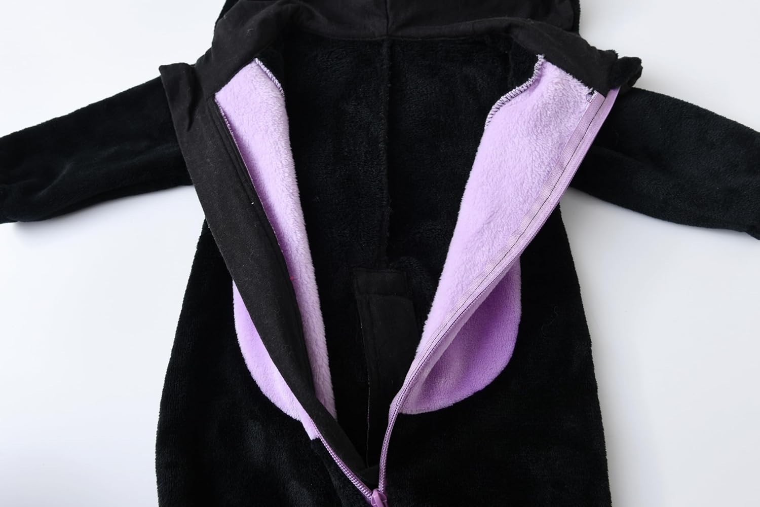 Black coat with purple lining on a mannequin against a white background