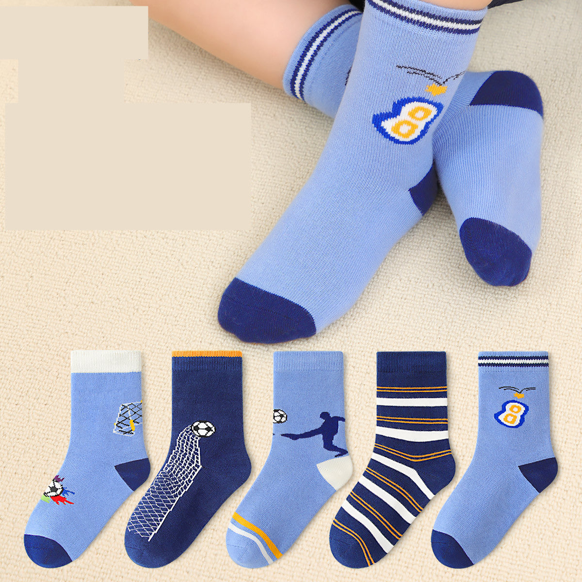 Set of blue socks with various designs on a beige surface
