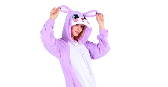 Person wearing a purple bunny onesie on a white background