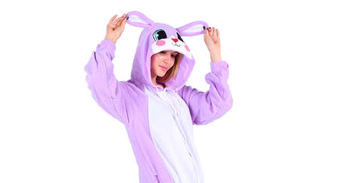 Person wearing a purple bunny onesie on a white background