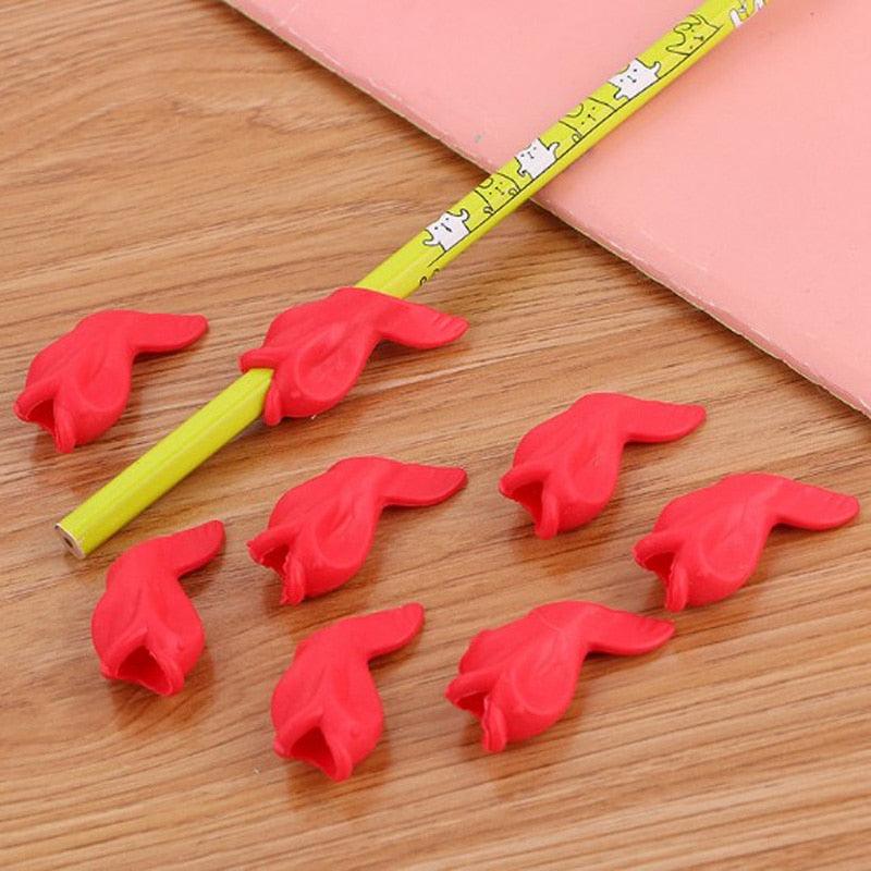 Red pencil caps scattered on a wooden surface with a yellow pencil.