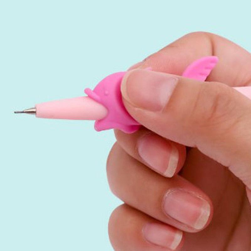 Hand holding a pink pen with a unique design against a light blue background