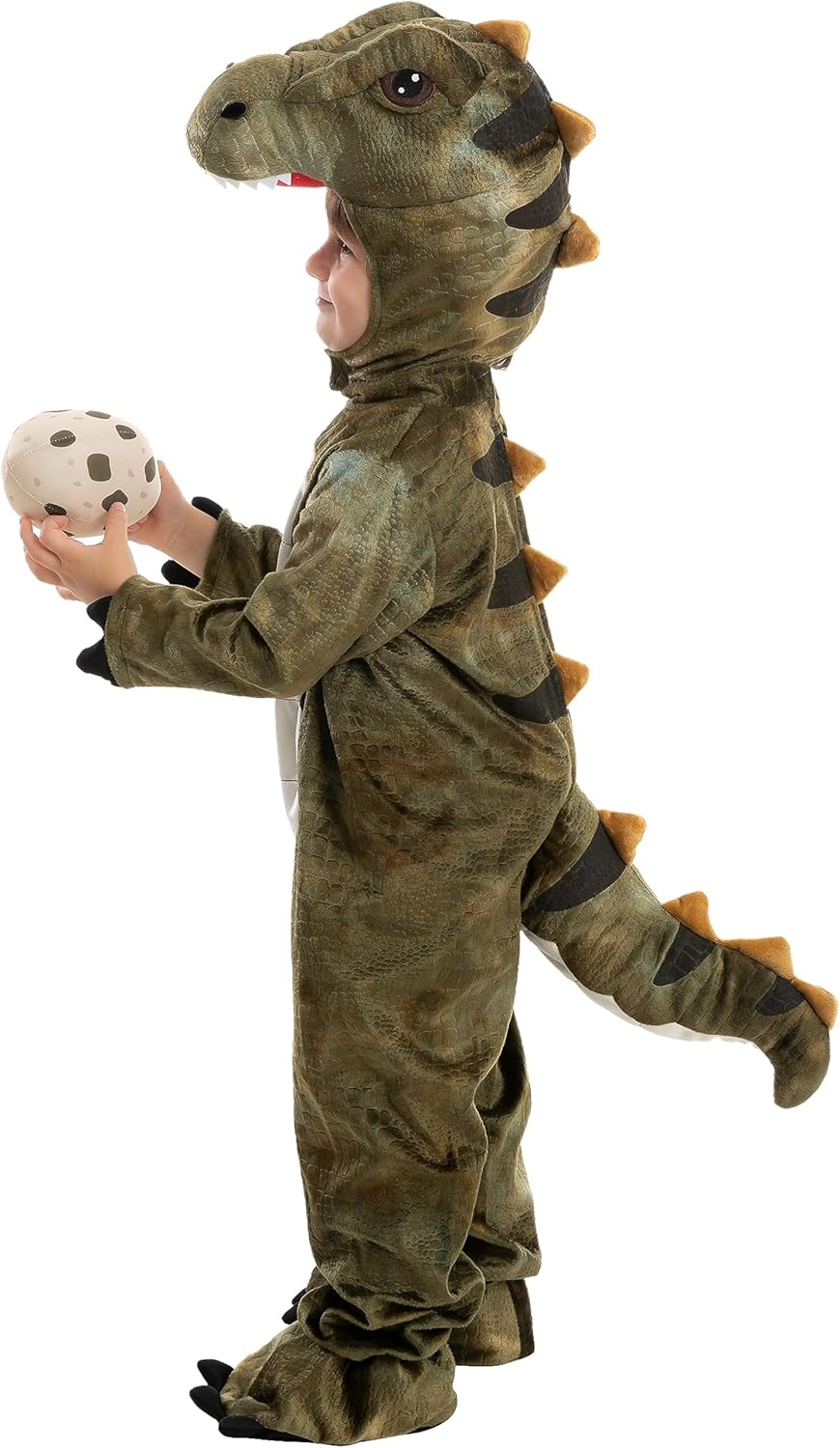 Child in a dinosaur costume holding a toy egg on a white background