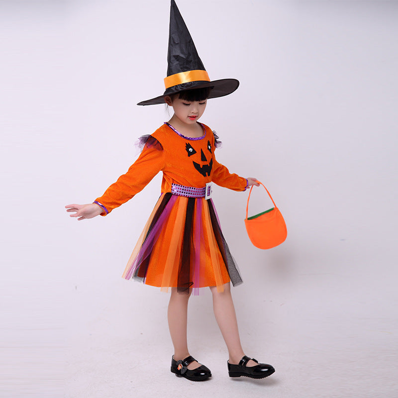 Child in Halloween costume with orange dress, black witch hat, and candy bag on a white background