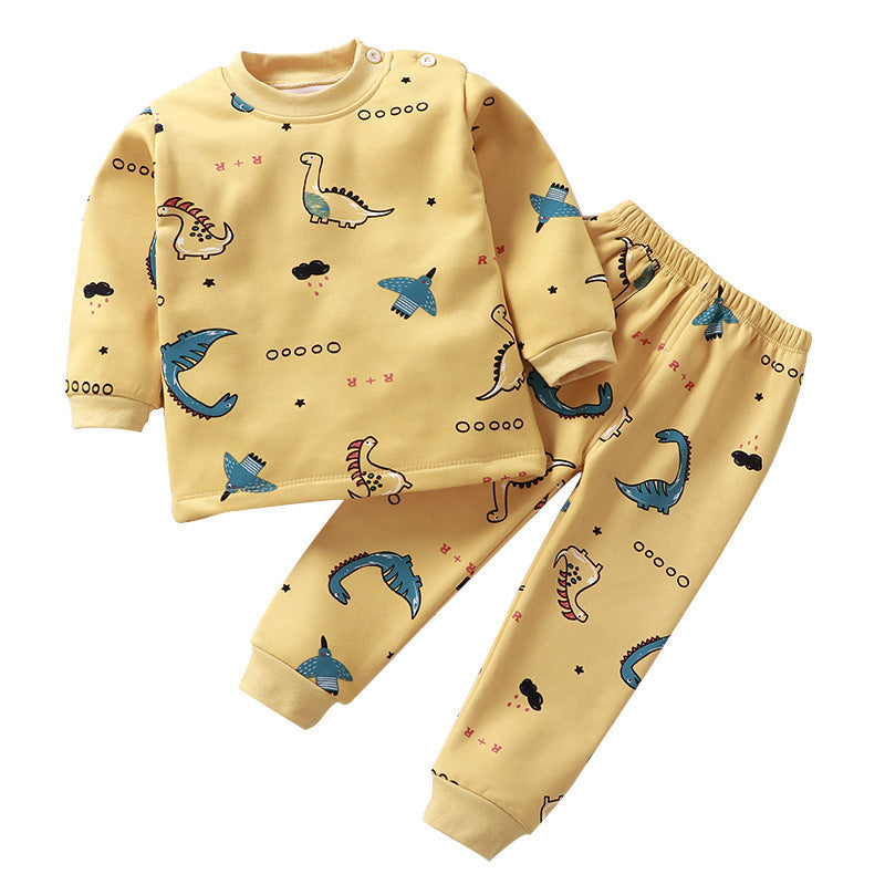 Yellow children's pajama set with dinosaur pattern on a white background