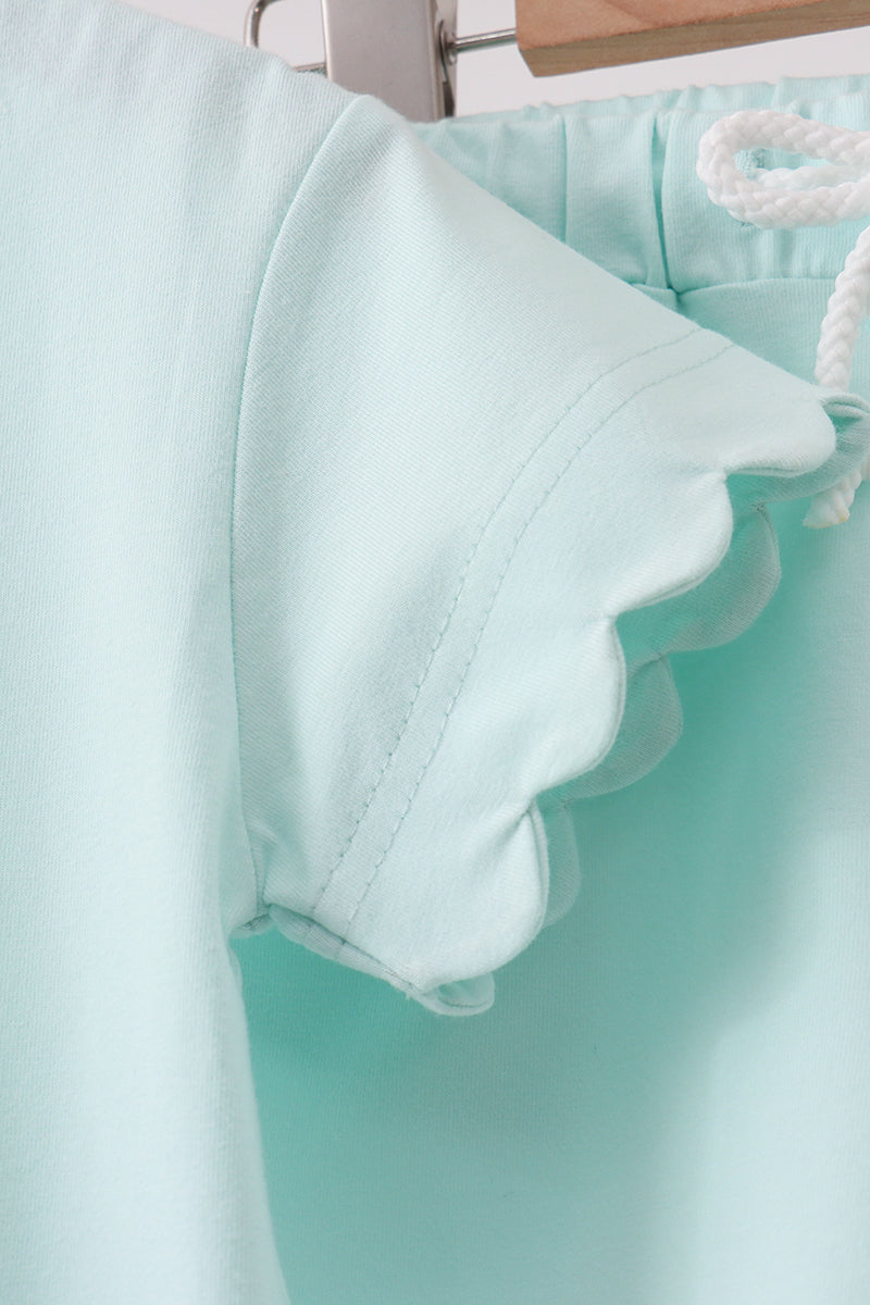 Light blue shorts with a ruffled hem on a white background