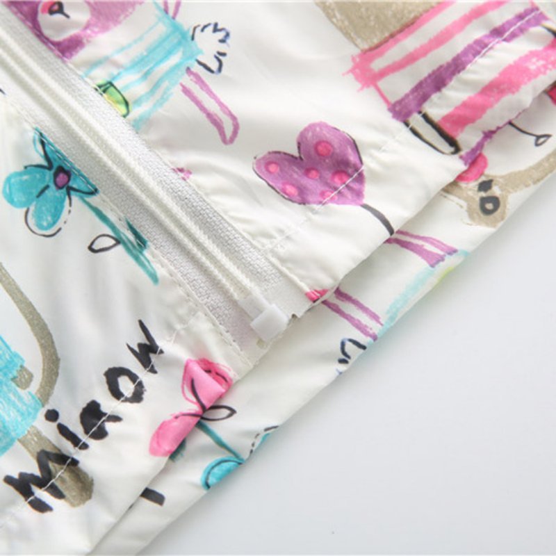 Close-up of colorful fabric with cartoon designs on a white background