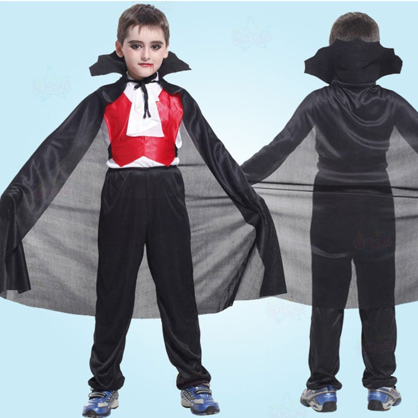 Child wearing a vampire costume with a cape and bat wings on a light blue background
