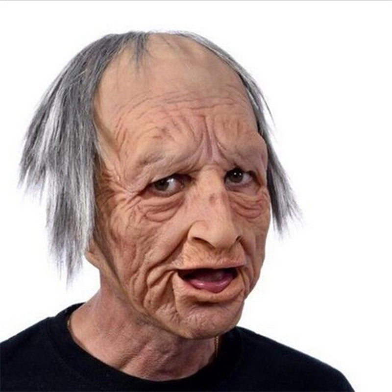Older person wearing a realistic old age mask on a white background