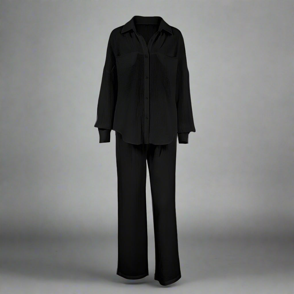 Black outfit with a shirt and pants on a gray background