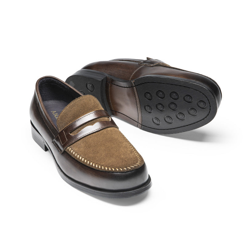 Brown loafers with a black sole on a white background