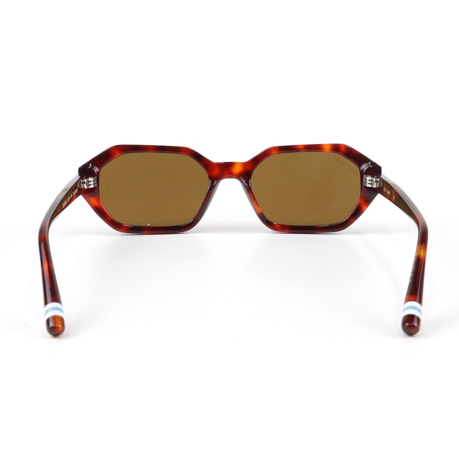 Sunglasses with tortoiseshell frame and brown lenses on a white background
